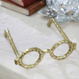 Aluminum eyeglass sculpture in gold on a table