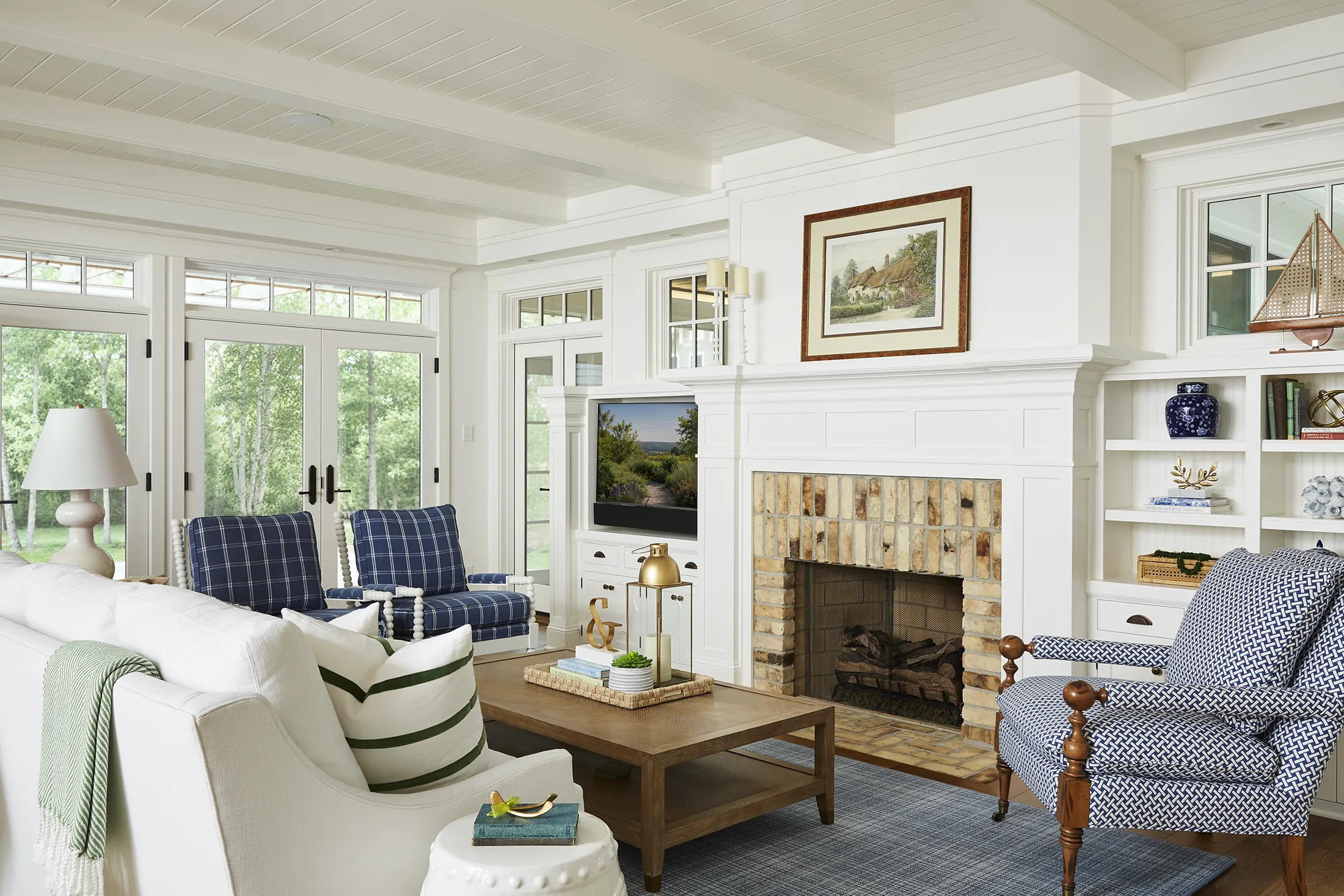 Bright lake house living room with fireplace and blue furnishings